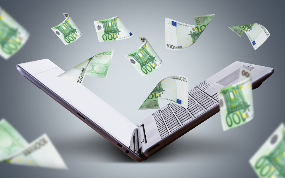Euro Banknotes Flying around Laptop